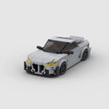 KORTEX Edge, maquette de coupé sportif gris mat en briques Mabric™ aux optiques jaunes