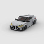 KORTEX Edge, maquette de coupé sportif gris mat en briques Mabric™ aux optiques jaunes